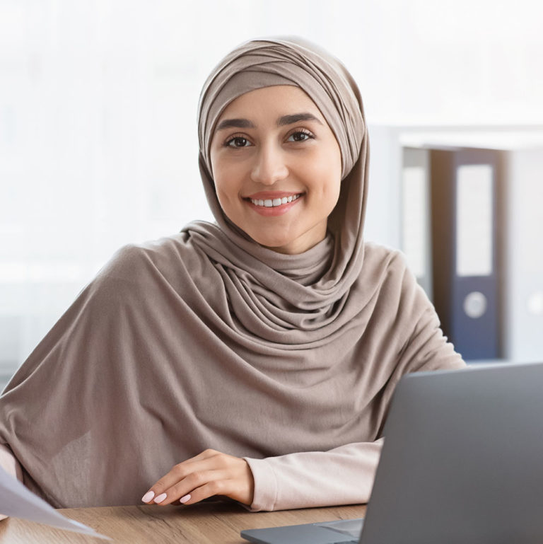 happy-muslim-businesswoman-in-hijab-with-papers-at-P8ZCCJX.jpg